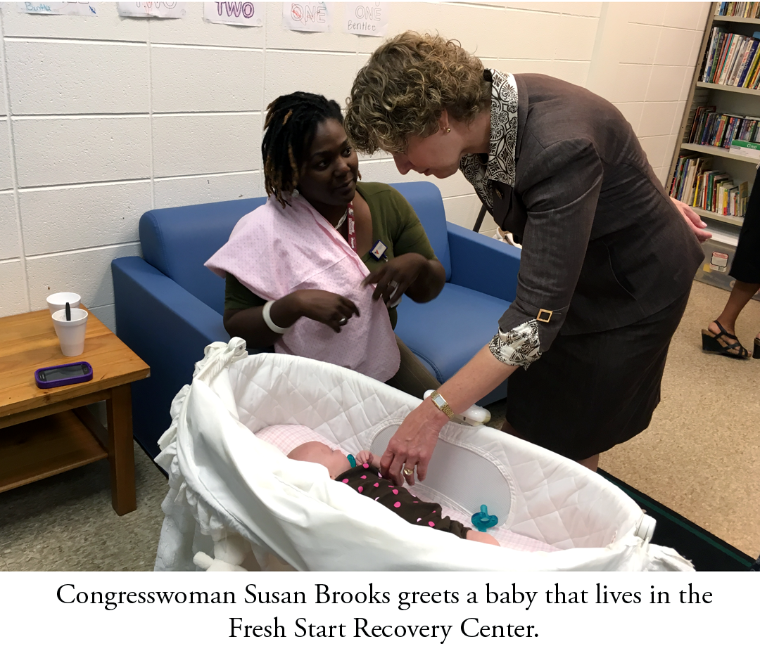 Congresswoman Brooks greets a child living in the Fresh Start Recovery Center